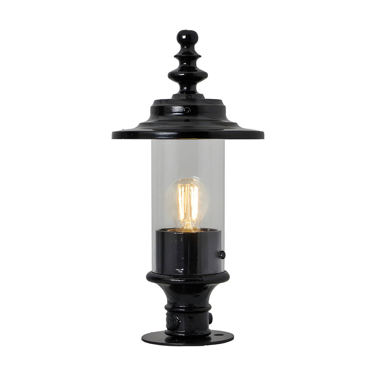 Cast iron Georgian lantern head in black with clear glass cylinder, ornate finial top and 44mm spigot fitting, shown lit on a black pedestal base against a plain white background.