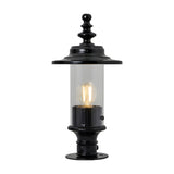 Cast iron Georgian lantern head in black with clear glass cylinder, ornate finial top and 44mm spigot fitting, shown lit on a black pedestal base against a plain white background.
