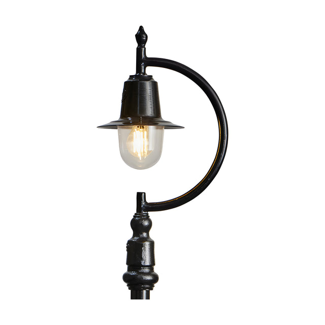 Cast iron teardrop lantern head with clear glass shade and lit bulb, black finish, 44mm fitting, mounted on a curved bracket arm and post for scale, plain white background.
