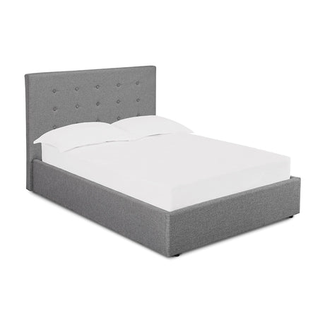 Lucca Double Plus Ottoman Bed Frame in grey fabric with a tall button-detailed headboard and upholstered base, dressed with white bedding on a plain white background.