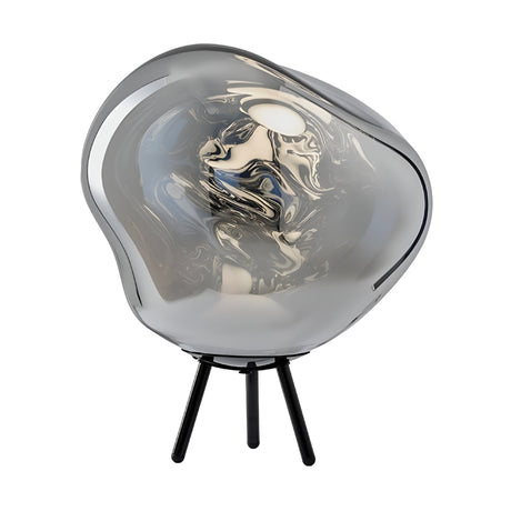 The Lava Large LED Floor Light - Silver features a modern, sculptural design with a smoky, irregular glass shade on a tripod base, displaying swirling patterns and a glossy, reflective surface.