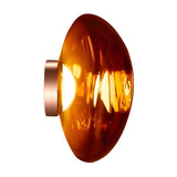 The Lava Large LED Wall & Ceiling Light - Copper features a shiny, amber-toned semi-translucent glass shade with a metallic base, dimmable LED functionality, and glows warmly against a white background.