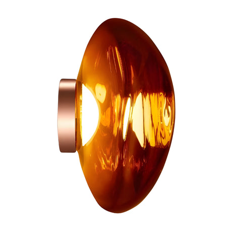 The Lava Large LED Wall & Ceiling Light - Copper features a shiny, amber-toned semi-translucent glass shade with a metallic base, dimmable LED functionality, and glows warmly against a white background.