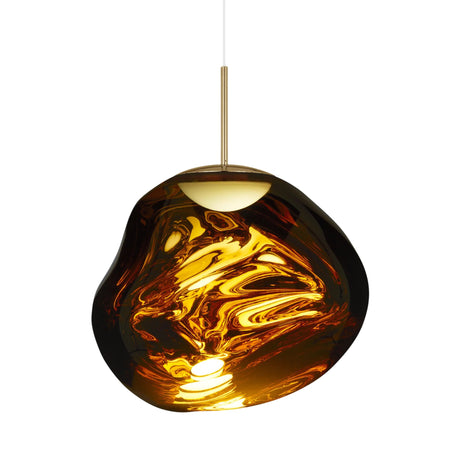 The Lava Medium LED Pendant Light - Gold features an irregular amber glass shade with swirling patterns, a brass-colored stem, and a white suspension cord, delivering ambient light and modern style to any space.