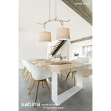 Sabina 2 Light E27 Pendant Light with beige linen drum shades hung from a branch-like imitation wood bar, shown above a wooden dining table in a bright interior.