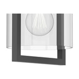 Close-up of the Maya E27 ceiling light showing the clear cylindrical glass shade, anthracite square frame bracket, and exposed globe bulb with visible filaments, on a plain white background.