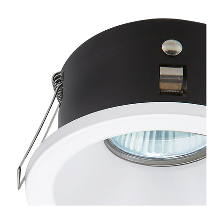 Close-up of the Comfort IP54 Round Downlight in matt white with black inner housing, showing the GU10 lampholder, spring clips, and shallow round rim.