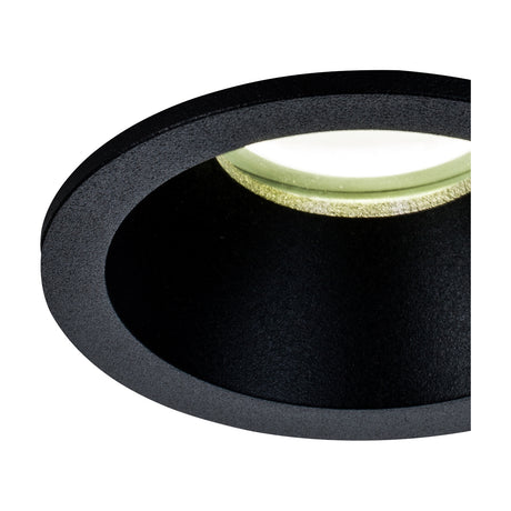 Close-up of the Comfort IP54 round downlight in matt black aluminium, showing the recessed circular housing and deep baffle with GU10 lampholder, set against a plain white background.