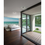 Lamborjini GU10 round spotlight, 93mm black recessed downlight, shown ceiling-mounted in a modern bedroom with glass doors opening onto a terrace.
