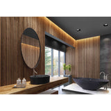Recessed square spotlight in matte black, 93mm face with 45-degree angled funnel, shown in a wood-panelled bathroom ceiling with GU10 fitting visible.