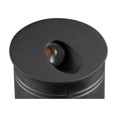 Close-up of the Aspen IP65 round recessed outdoor wall light in sand black, showing its angled aluminium face with integrated LED against a white background.