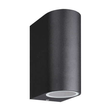 Kandanchu 2 Light Round Outdoor Wall Light in sand black, cylindrical aluminium body with matt textured finish and visible GU10 lamp aperture, shown on a plain white background.