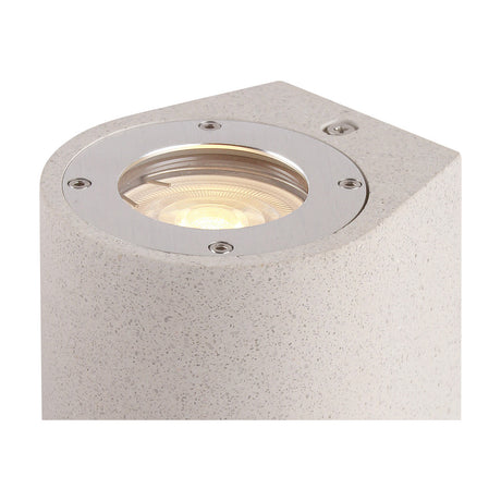 Close-up of the Levi IP65 round outdoor wall light in white concrete, showing the angled top with a chrome-ringed GU10 lamp fitting and visible screws.
