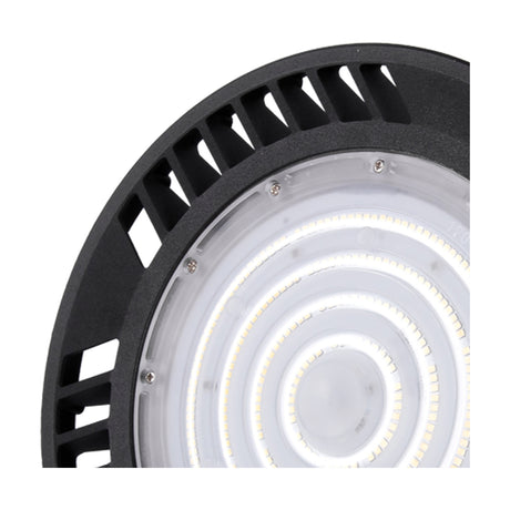 Close-up of the Urano UFO-style downlight in black aluminium, showing concentric LED rings, screws and vent slats on a round 26cm body against a white background.
