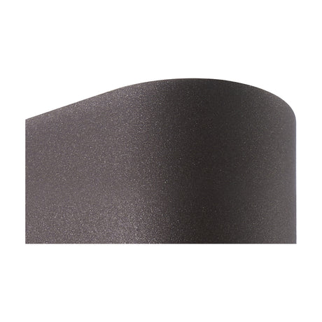 Close-up of the Kandanchu Round Outdoor Wall Light in rust brown, showing its curved aluminium body with a textured matte finish on a plain background.