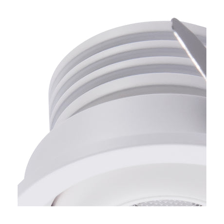 Close-up of the Neptuno Recessed Spotlight, a small round white trim with a tilting integrated LED head, showing ribbed housing detail against a plain background.
