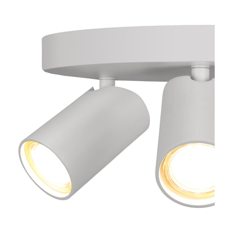 Close-up of the Sal 3 Light GU10 Round Spotlight in matt white, showing two adjustable cylindrical heads with lit GU10 bulbs mounted on a round ceiling plate.