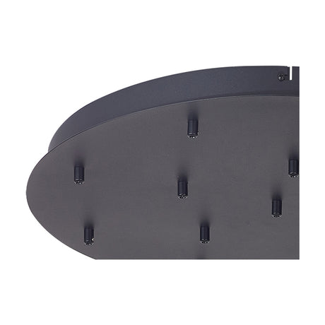 Close-up of the Tonic Round Canopy Kit 60cm in black, a shallow metal ceiling plate with multiple flex holes and mounting pins, shown against a plain white background.
