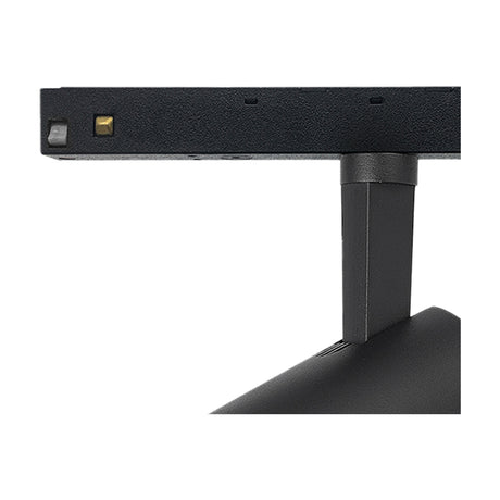 Close-up of the Magneto 20W Track Light in black, showing the 65mm cylindrical spotlight head on a pivoting knuckle mount attached to the track, against a plain white background.