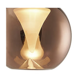 Close-up of the Andromeda Round Lamp Shade 13cm in Copper, showing the domed copper glass exterior and frosted inner funnel glowing softly when lit.