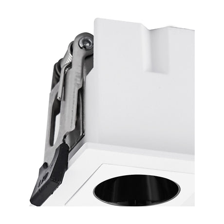 Close-up of the Blau 3W square recessed downlight in white aluminium, showing the black bezel aperture and metal spring clip fitting against a plain white background.