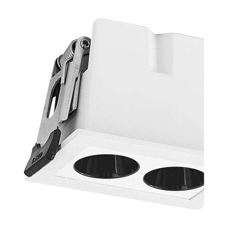 Close-up of the Blau 2 Light Downlight in white aluminium, showing the rectangular housing, twin black-trimmed apertures, and metal mounting clip against a plain background.