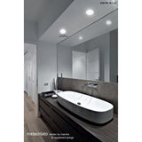 Metacrilato Acrylic Downlight, 80mm cut-out, 7W 4000K matt white recessed fixture shown installed in a bathroom ceiling above a mirror and countertop basin.
