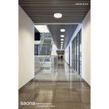Saona round recessed downlights in matt white with frosted acrylic diffusers, installed in a series along a ceiling above a modern office hallway.