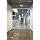 Saona Recessed Round Downlight 210mm Cut-Out, matt white ceiling fitting shown installed in rows along a corridor ceiling above glossy floor tiles.