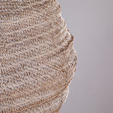 Close-up of the Mukuni Large Wire Lampshade in brass, showing its knitted mesh of interlocking wire loops forming horizontal ridged bands, against a plain light grey background.