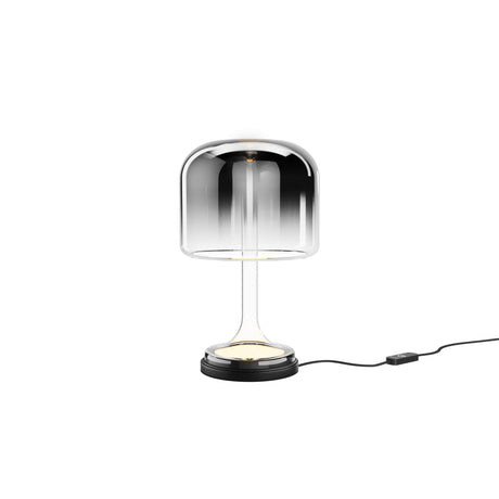 Maytoni Spirito LED table lamp with chrome-to-clear glass dome shade on a chrome pedestal and black marble-effect base, inline dimmer cable, on white.