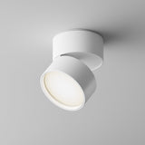 The Onda LED Single Spotlight 12W 4000K in white is a modern cylindrical ceiling fixture with an adjustable head that emits a soft, warm glow on a smooth white ceiling, providing energy-efficient performance.
