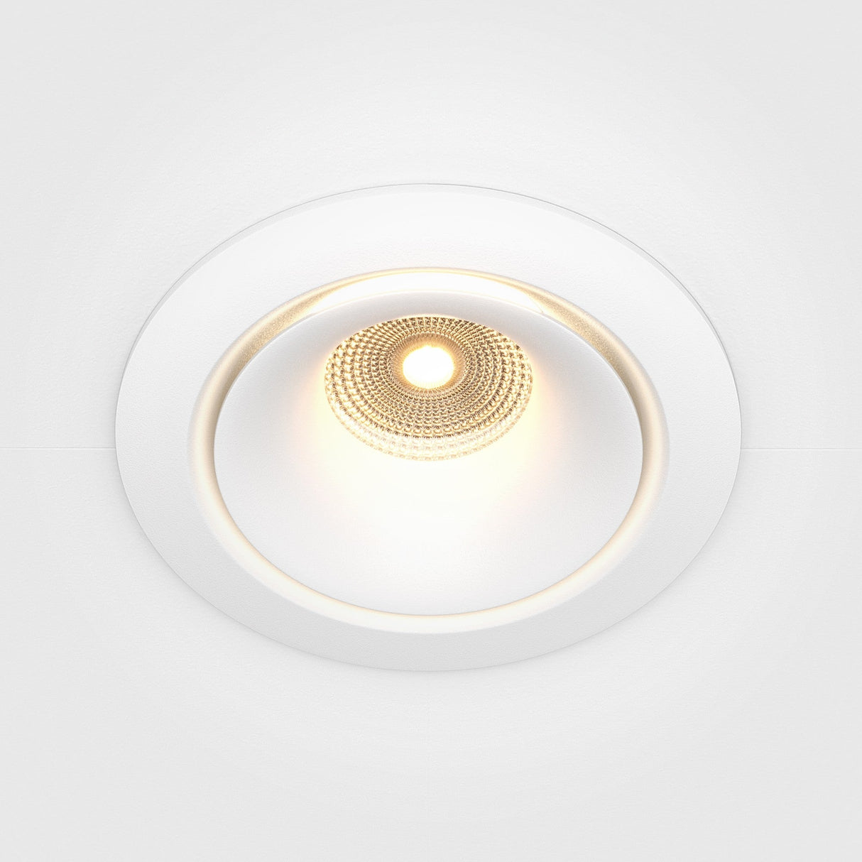The Yin LED Dimmable Round Recessed Downlight offers a central illumination, white trim, and a soft 3000K glow.