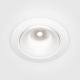 The Yin LED Dimmable Round Recessed Downlight 12W 4000K - White features a sleek design with a circular shape and white trim. Its textured, metallic interior creates intricate light patterns on a smooth white ceiling, offering adjustable brightness to suit any ambiance.