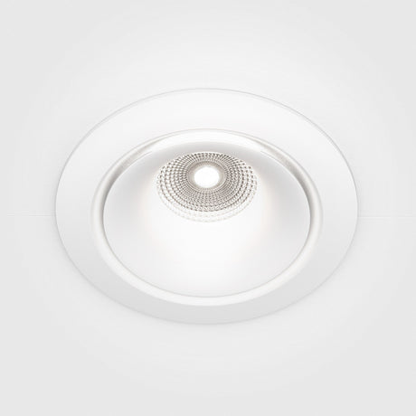 The Yin LED Dimmable Round Recessed Downlight 12W 4000K - White features a sleek design with a circular shape and white trim. Its textured, metallic interior creates intricate light patterns on a smooth white ceiling, offering adjustable brightness to suit any ambiance.