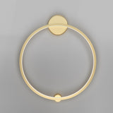 The Halo LED Medium Ring Wall Light 36W 4000K features a circular, modern design with a brass finish, emitting a soft glow for an elegant ambiance against neutral gray walls, while being energy-efficient.