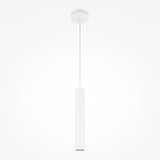 The Pro Focus Thin Pendant Light - White, featuring a minimalist cylindrical white shade, hangs from a slim cord connected to a round ceiling mount, with the plain white background enhancing its ambient lighting effect.