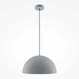 The Basic Colors Dome Pendant Light in matte grey features a minimalist dome design and sleek modern aesthetics. It hangs from a ceiling mount with a long, straight cord, perfectly complementing contemporary interiors against a plain white background.
