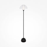 The Memory Floor Lamp - Black features a modern design with an opal white glass shade. Its minimalist black stand, round base, and sleek aesthetic stand elegantly against a plain white background.