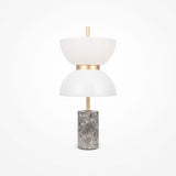 The Kyoto LED Table Lamp combines a grey marble base with two white, bowl-shaped shades, separated by a gold accent. Its minimalist design is centered around a vertical rod, making it an ideal fit for modern spaces.