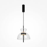The Bangkok LED Pendant Light 25cm offers a minimalist design with a sleek black rod and dual clear glass domes. The upper dome encloses an LED bulb, while the larger dome hangs below, all suspended from an elegant black ceiling fixture.