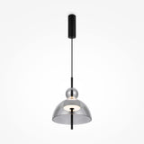 The Bangkok LED Pendant Light 25cm - Black with Round Smoky Glass Shade offers modern elegance with its smoky shade, black rod, and cylindrical ceiling mount. The central bulb emits a soft glow, enhancing its minimalist design.