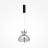 The Bangkok LED Pendant Light 25cm features a sleek black metal fixture and smoky bell-shaped glass shade, with a central bulb suspended from a slim black cord attached to a cylindrical ceiling mount.
