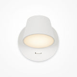 The Pixel LED Wall Light in white is a ceiling-mounted fixture with a simple modern design. It offers central task lighting with a soft glow, surrounded by a shadowed rim, and features a small rectangular notch for energy-efficient illumination.