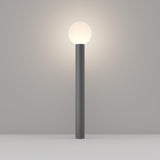 The Bold Bollard Light 80cm - Grey is a minimalist floor lamp featuring a cylindrical gray base and a glowing spherical white light, showcasing modern design on a neutral gray background.