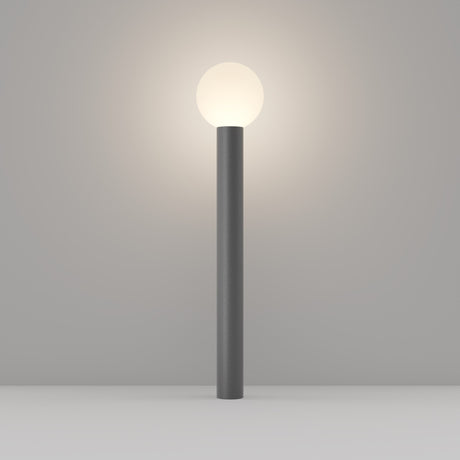 The Bold Bollard Light 80cm - Grey is a minimalist floor lamp featuring a cylindrical gray base and a glowing spherical white light, showcasing modern design on a neutral gray background.