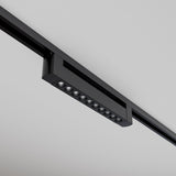 Close-up of the sleek Points Rot LED Swivel Linear Track Light with a modern matte black finish, featuring multiple circular bulbs on a black track against a white ceiling. This minimalist design boasts a 10W output, 3000K color temperature, and ensures high color rendering index (CRI).
