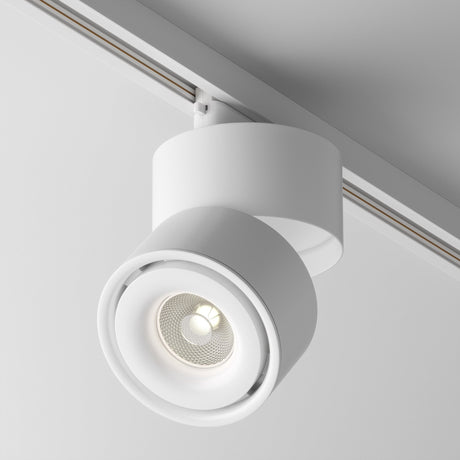 A close-up of the contemporary Yin LED Dimmable Single Phase Unity Track Spotlight shows its white, circular design. This 15W, 4000K fixture offers a minimalist vibe and CRI 90 lighting for vibrant illumination against a plain ceiling backdrop.