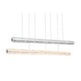 Two Liora LED Crystal Suspension Lights in chrome hang by thin wires—one illuminated, one off—both showcasing a modern, transparent cylindrical design for a sleek and refined aesthetic.