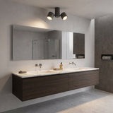 Ideal Lux Beamglasses LED triple spotlight in grey metal, ceiling-mounted with adjustable cylindrical heads, above a wood vanity and mirror in a bathroom.
